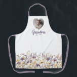 Grandma Purple Watercolor Wildflowers & Photo Gift Apron<br><div class="desc">Personalised floral aprons for Grandma make a heartfelt and practical gift that blends beauty with everyday usefulness. This custom apron design features a heart-shaped photo frame above the editable word “Grandma” and a customisable “Est. [Year]” to celebrate the birth of her first grandchild or commemorate her special role in the...</div>