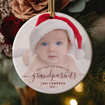 Grandparents First Christmas Photo Red Script Ceramic Tree Decoration<br><div class="desc">Help them celebrate their first grandchild with this beautiful modern keepsake ornament. The burgundy red text reads "Our first Christmas as grandparents, " with the word "grandparents" in elegant handwriting script with flourishes before and after. Easily replace the sample image with your favourite photo of the new baby, and add...</div>