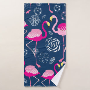 Graphic pattern of pink flamingos on a dark blue b bath towel