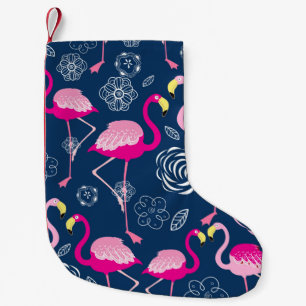 Graphic pattern of pink flamingos on a dark blue b small christmas stocking