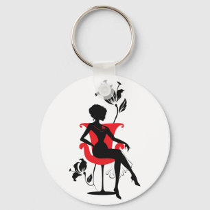 Graphic silhouette of a woman sitting in red chair key ring