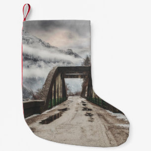 GRAY CONCRETE ARCH BRIDE BESIDE LEAFLESS TREE NEAR SMALL CHRISTMAS STOCKING