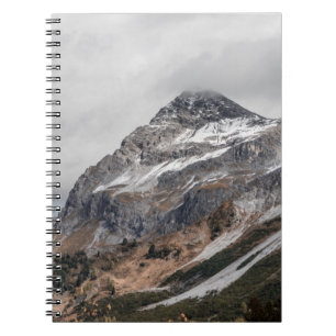 GRAY MOUNTAINS WITH SNOW CAPPED SURROUNDED WITH TR NOTEBOOK