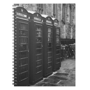 GRAYSCALE PHOTO OF FOUR TELEPHONE BOOTHS LINED UP NOTEBOOK