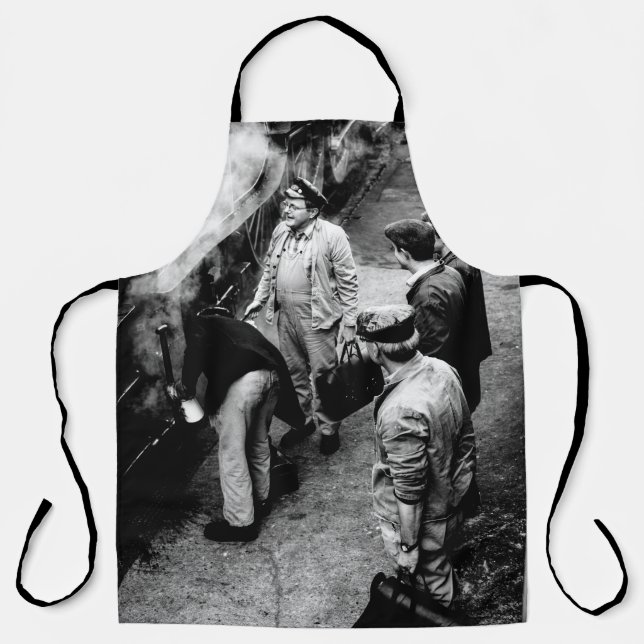 GRAYSCALE PHOTO OF MEN STANDING BESIDE 60163 TRAIN APRON (Front)