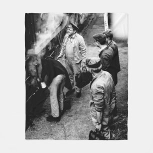GRAYSCALE PHOTO OF MEN STANDING BESIDE 60163 TRAIN FLEECE BLANKET