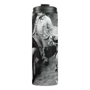 GRAYSCALE PHOTO OF MEN STANDING BESIDE 60163 TRAIN THERMAL TUMBLER