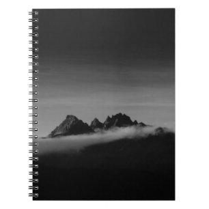 GRAYSCALE PHOTO OF MOUNTAIN COVERED WITH CLOUDS NOTEBOOK