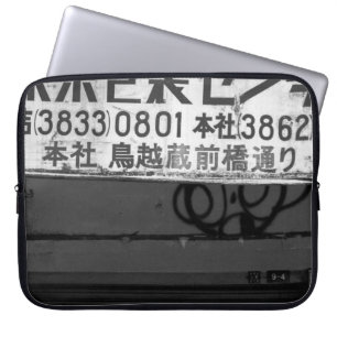 GRAYSCALE PHOTOGRAPHY OF STORE SIGN LAPTOP SLEEVE