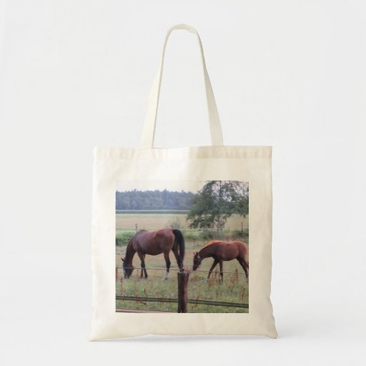 Image of Grazing mother horse and foal. Tote Bag