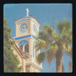 Greece - Orthodox Greek Church with Palm Tree Stone Coaster<br><div class="desc">A bright and summery photograph taken in Greece. An orthodox greek church and its quaint clock tower and steeple. Vibrant colours on this structure are sandstone coloured brick with accents in santorini blue. A giant leafy palm tree hovers above. The sky is clear blue and shows off the stark white...</div>