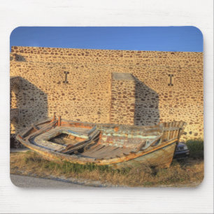 Greece, Santorini, Oia. Old fishing boat on dry Mouse Mat