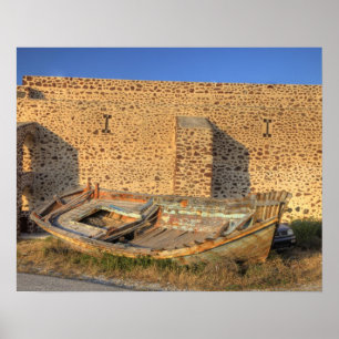 Greece, Santorini, Oia. Old fishing boat on dry Poster