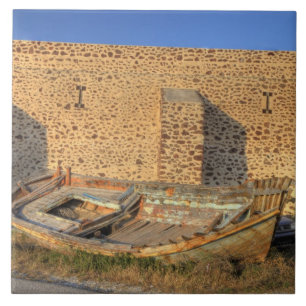 Greece, Santorini, Oia. Old fishing boat on dry Tile