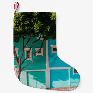 Green and blue houses beside trees on sidewalk small christmas stocking