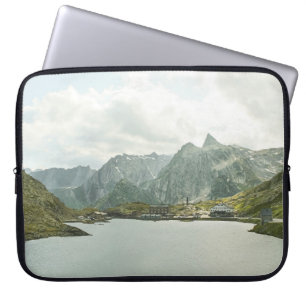 GREEN AND BROWN MOUNTAINS NEAR BODY OF WATER UNDER LAPTOP SLEEVE