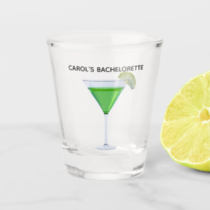 Green appletini cocktail with slice of apple shot glass