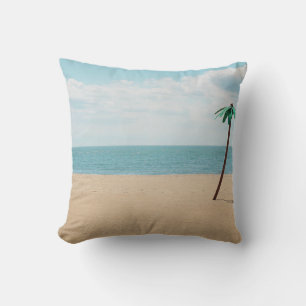 Green artificial palm tree on seashore cushion