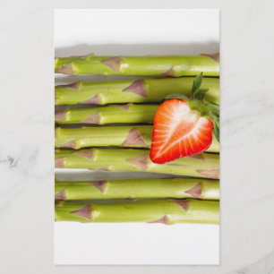 Green asparagus with strawberries top view stationery