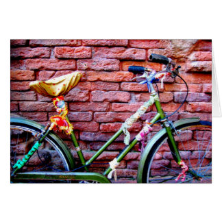 Green Bicycle Leaning Against a Brick Wall