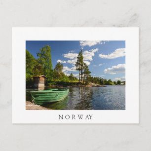 Green boat in a fjord in Norway white postcard
