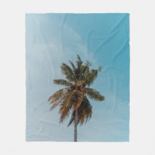 Green coconut tree under blue sky fleece blanket