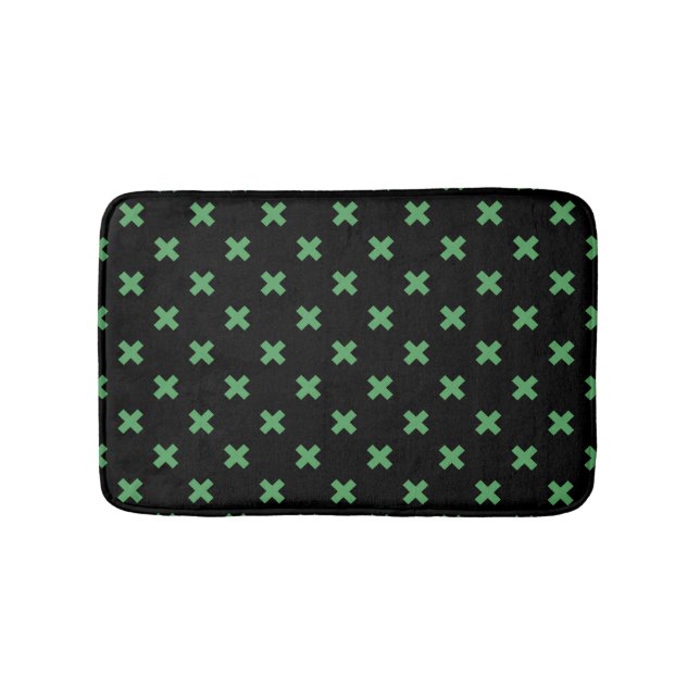 Green cross stitches on black bath mat (Front)