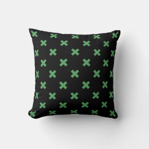 Green cross stitches on black cushion