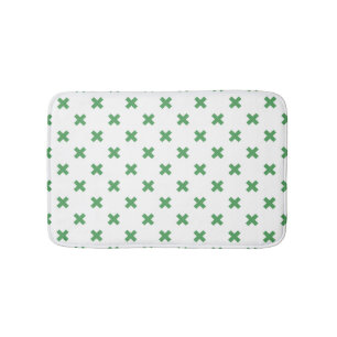 Green cross stitches on white bath mat