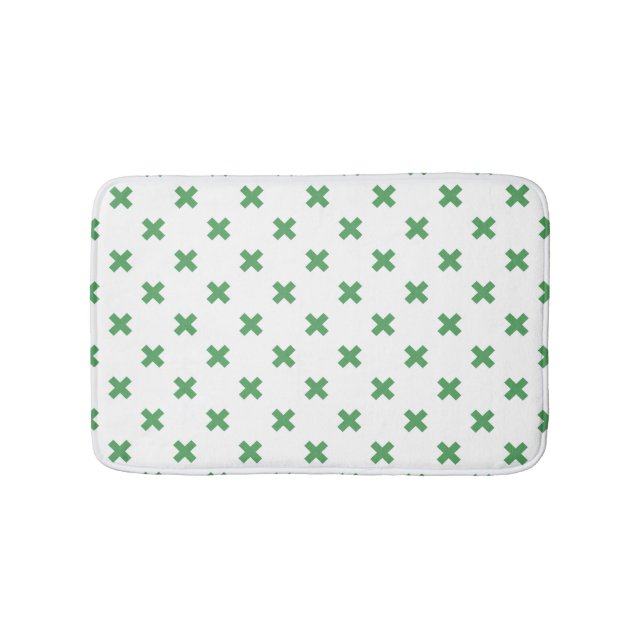 Green cross stitches on white bath mat (Front)