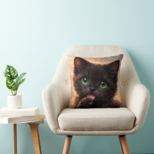 Green-Eyed Black Paw licking Kitten Cushion