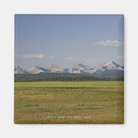 Green Fields And Rolling Hills With Mountains