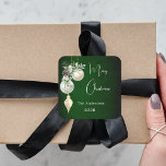 Green gold white baubles Christmas Square Sticker<br><div class="desc">For a Christmas party favours or gift wrapping. A rustic green uneven coloured background. Decorated with white and gold baubles and some greenery and a pine cone.  Personalise and add your name,  year.  Text: Merry Christmas</div>