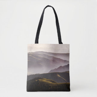 GREEN GRASS FIELD AND MOUNTAINS DURING DAYTIME TOTE BAG