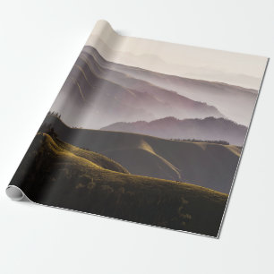 GREEN GRASS FIELD AND MOUNTAINS DURING DAYTIME WRAPPING PAPER