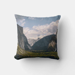 GREEN GRASS FIELD NEAR ROCKY MOUNTAIN UNDER WHITE  CUSHION