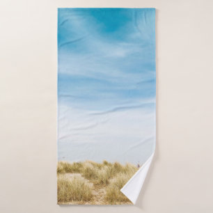 Green grass field under blue skies bath towel