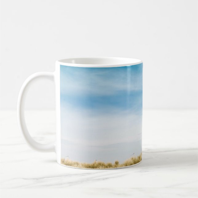 Green grass field under blue skies coffee mug (Left)
