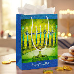Green Hanukkah Menorah Peace Love Light Script Medium Gift Bag<br><div class="desc">“Peace, love & light.” A close-up photo illustration of a bright, colourful, green and yellow artsy menorah against a blue faux glitter background helps you usher in the holiday of Hanukkah in style. Feel the warmth and joy of the holiday season whenever you use this cute and fun custom medium...</div>