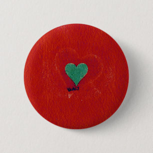 Green heart on a red grunge background 6 cm round badge