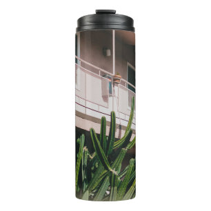GREEN LEAFED PLANT NEAR BUILDING THERMAL TUMBLER