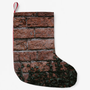 Green-leafed plants near brick wall small christmas stocking