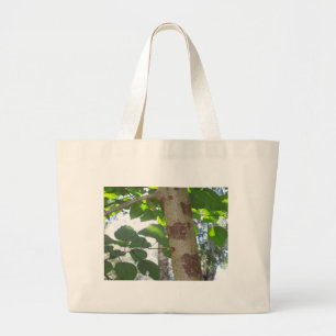 green leaves and tree trunk with cool bark large tote bag