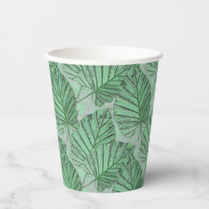 Green leaves on a grey stone. paper cups