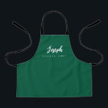 Green Little Chef Script Name personalised Kids Apron<br><div class="desc">Make your little chef feel extra special with our Green Little Chef Script Name Personalised Kids Apron. This apron is designed to provide a simple, chic, and elegant look, featuring stylish script typography for personalising the name. The purple background colour adds a touch of vibrancy and fun, perfect for engaging...</div>