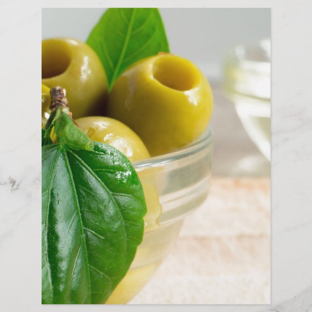 Green marinated olives pitted in a glass cup (Front)