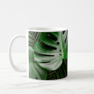 Green monstera leaves and palm leaves coffee mug