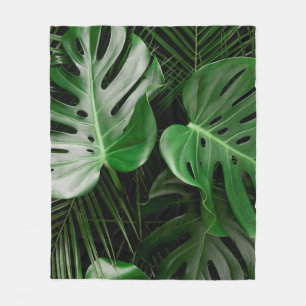 Green monstera leaves and palm leaves fleece blanket