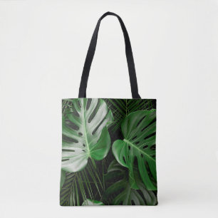 Green monstera leaves and palm leaves tote bag