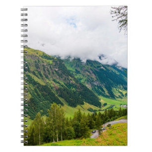 Green mountains covered with forest and green gras notebook